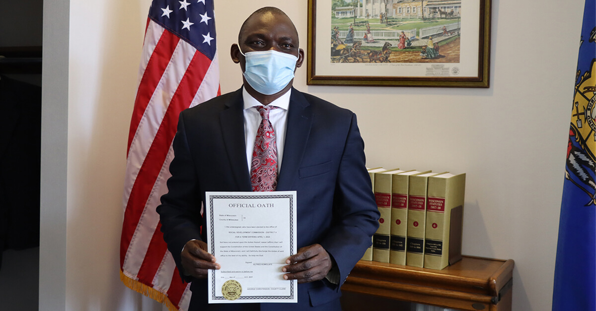 Commissioner posing with his certificate