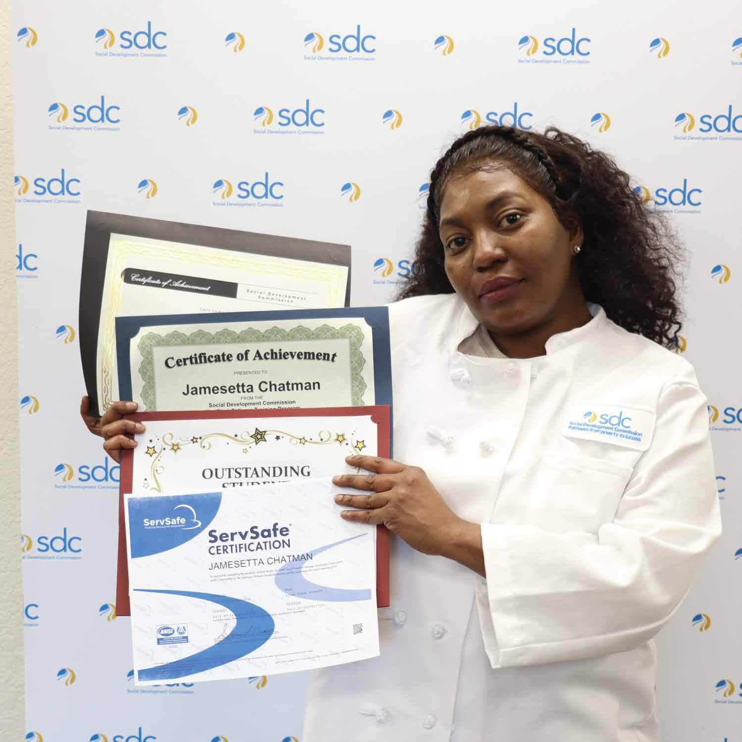 woman posing with certifications